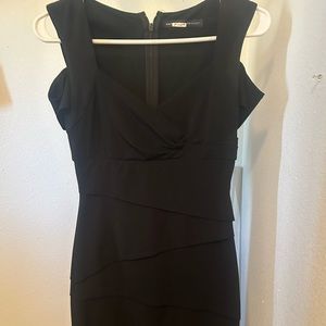 Black dress cut out sleeves and tiered fabric front and back.